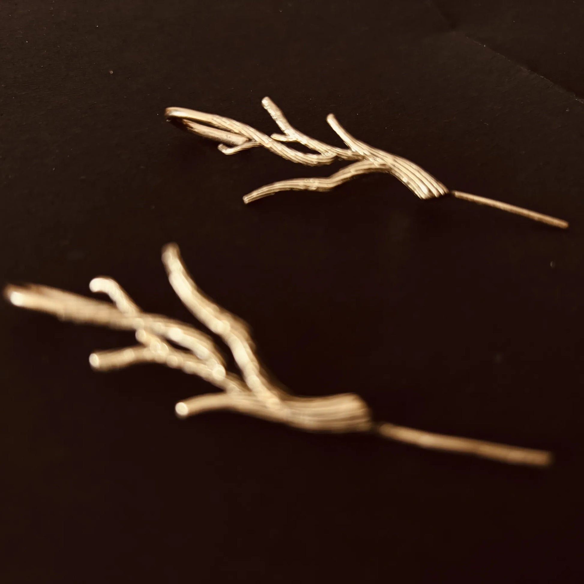 Close-up of Barebranch earrings showing organic curves and texture