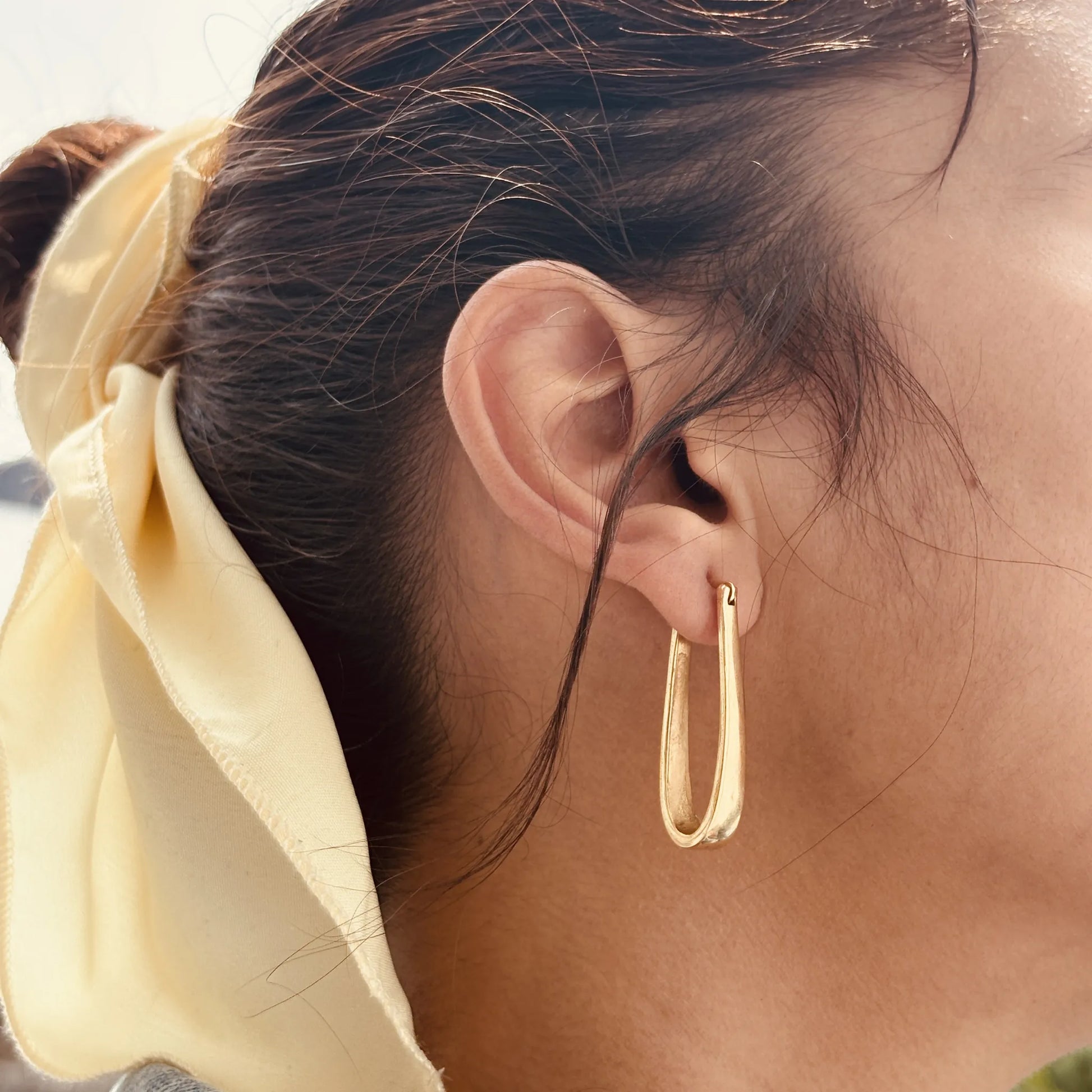 Echo Hoops worn on ear with yellow scarf, natural light