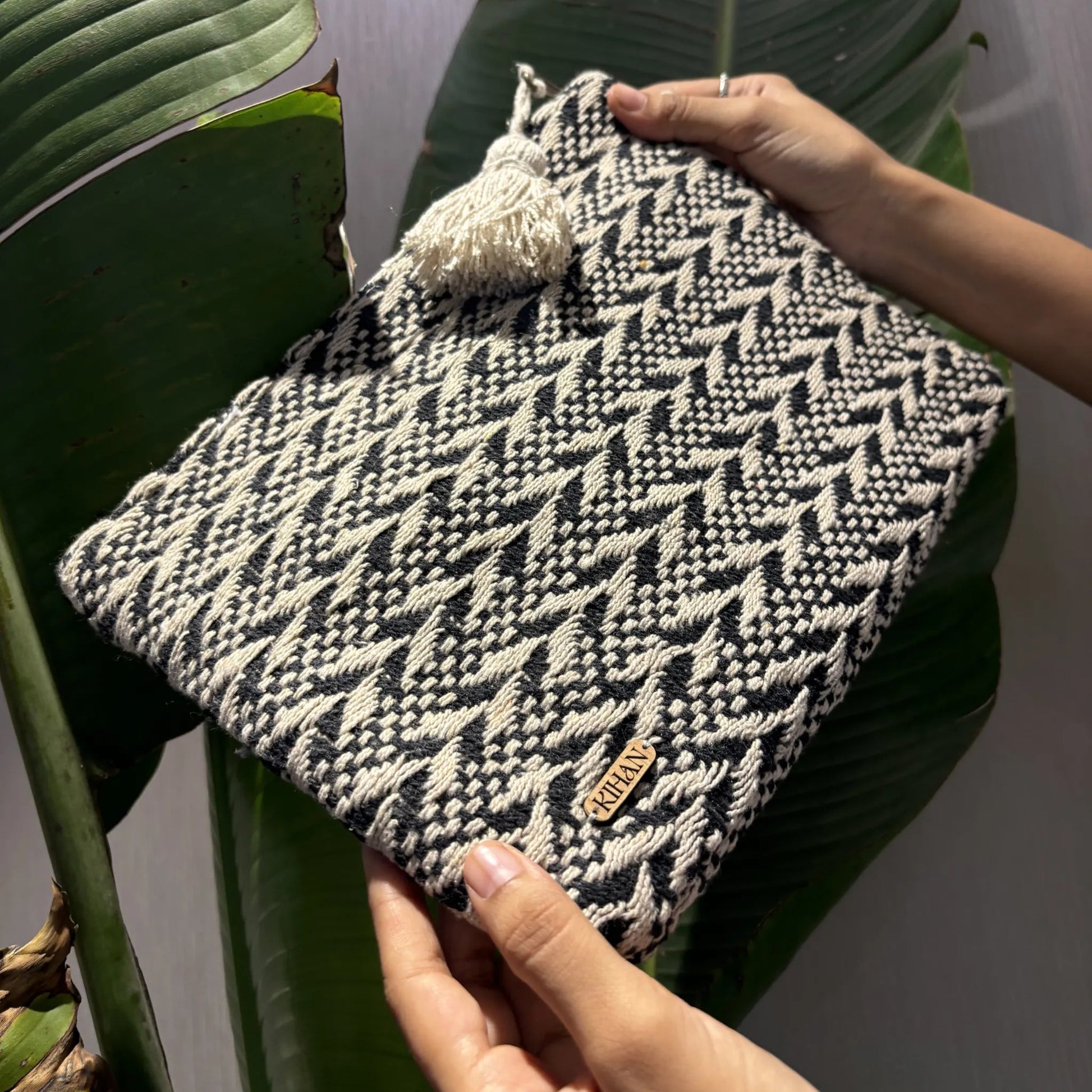 Handloom pouch multipurpose in black woven - holding view