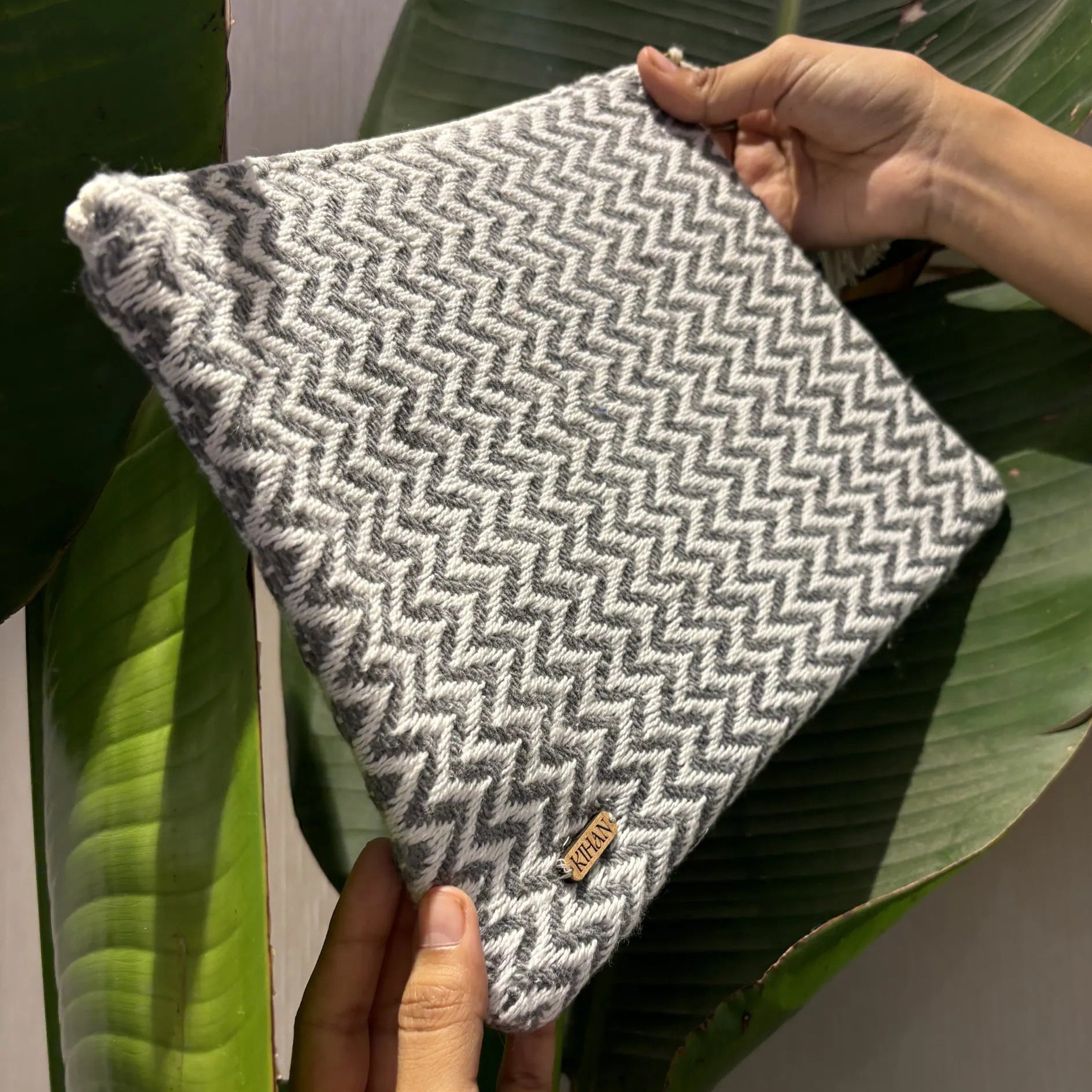 Handloom pouch multipurpose in grey zigzag - holding view