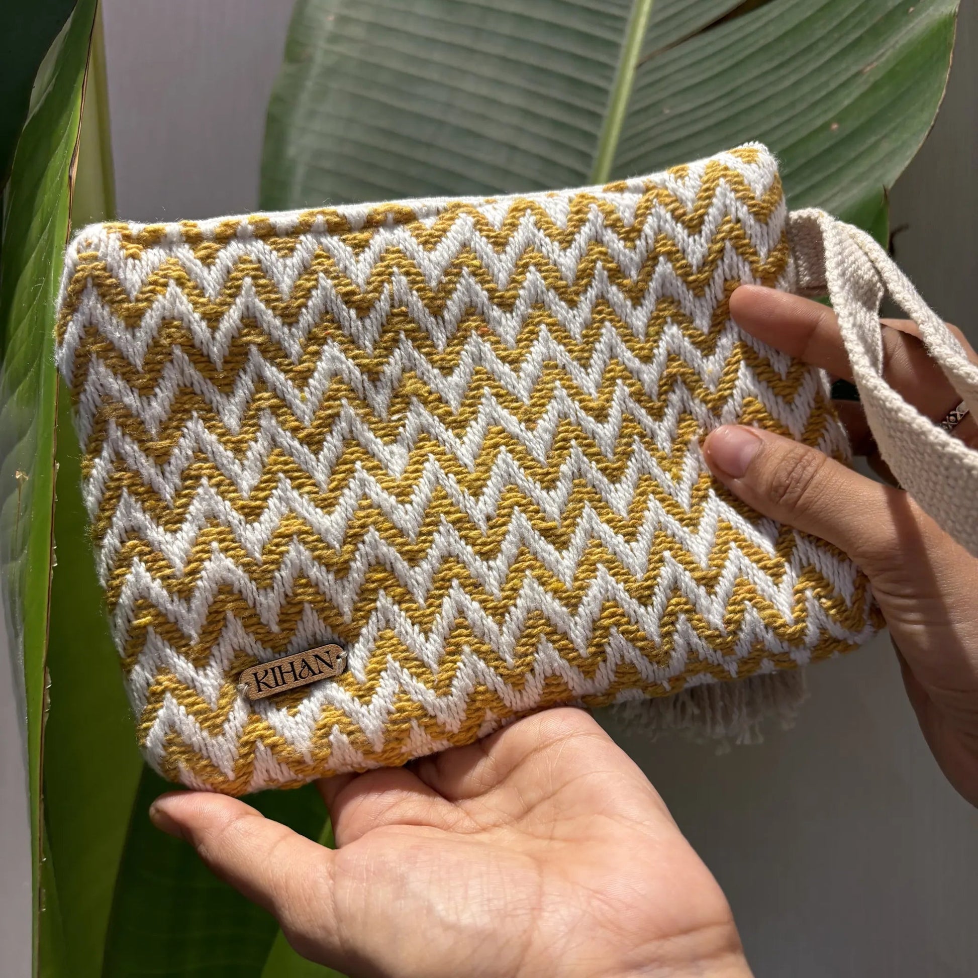 Handloom pouch multipurpose in marigold zigzag - holding view