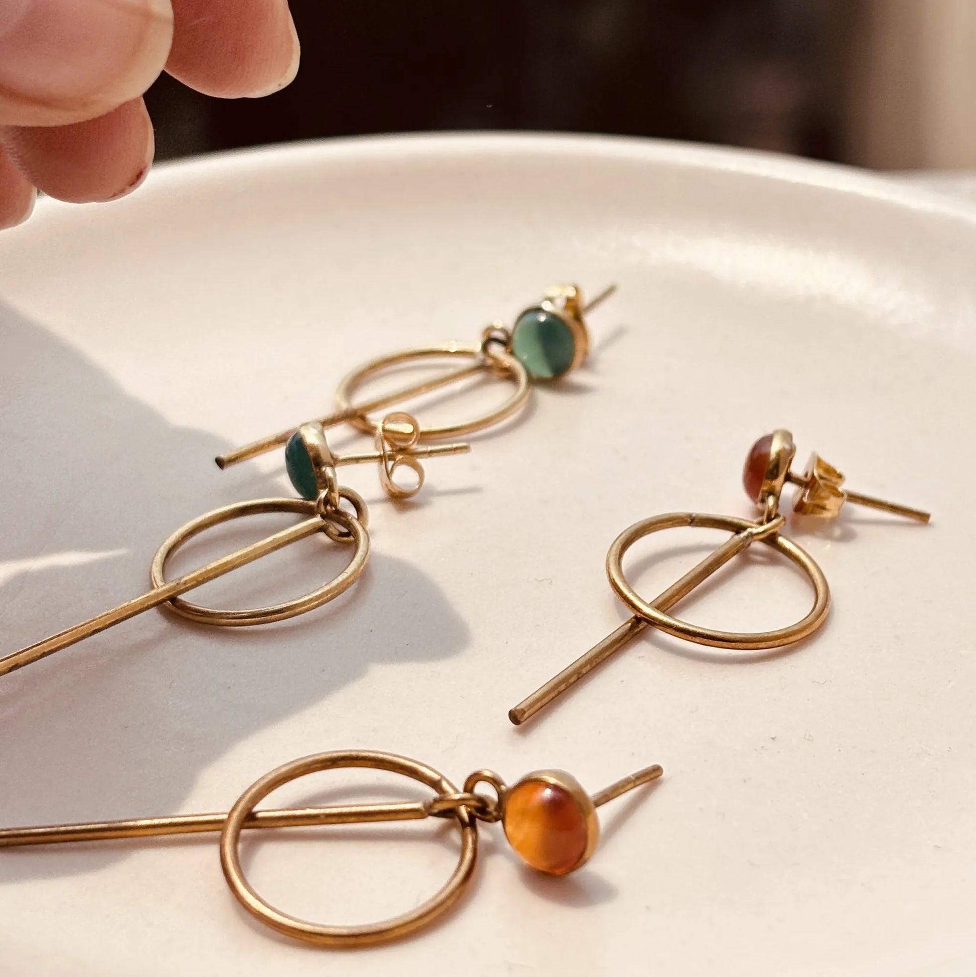 Green onyx and carnelian orbit drops earrings side by side