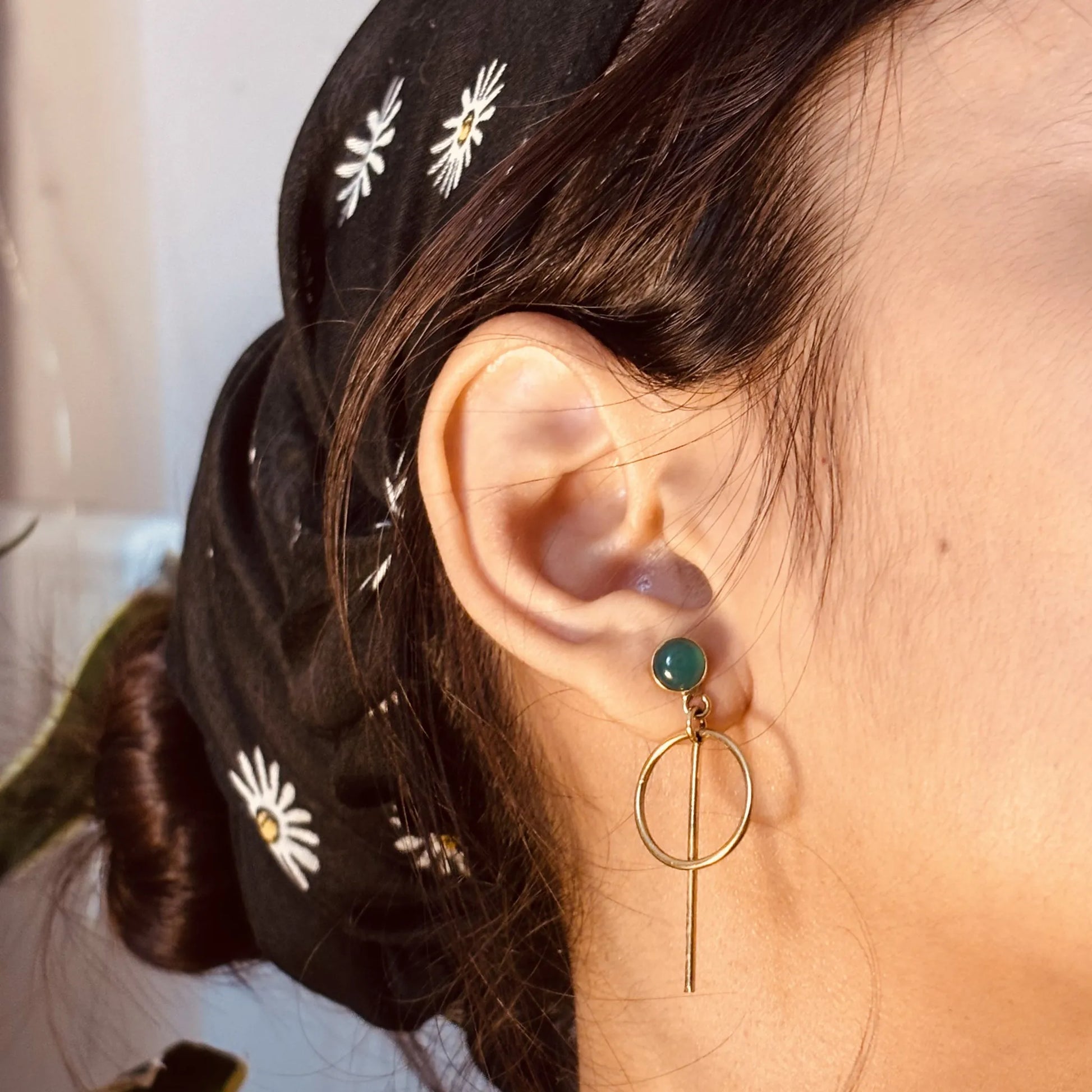 Orbit drops with green onyx worn on ear