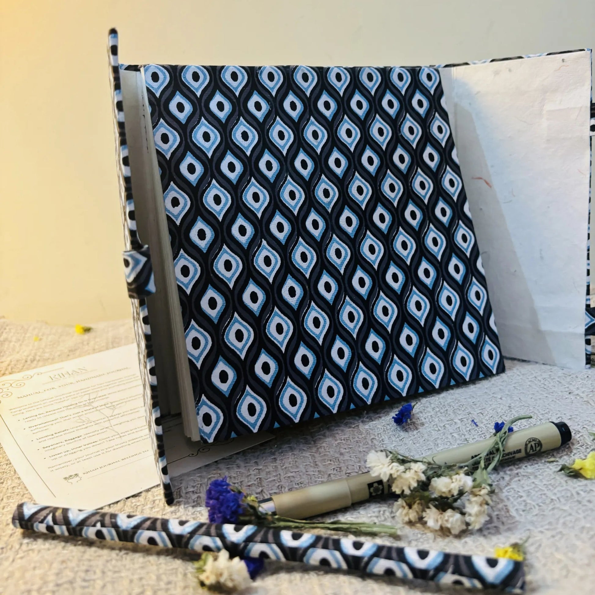 Handmade paper pen journal in evil eye - open view