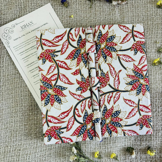 Handmade paper pen journal in floral harmony - flatlay view
