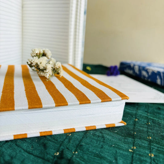 Handmade paper hardbound ruled journal in sunrise stripes - flatlay view