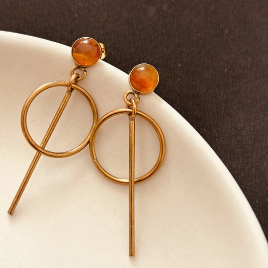 Carnelian orbit drops earrings on white plate